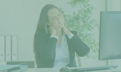 A woman in a suit tilting her head to the right, pressing her neck with both hands, indicating she is struggling with neck pain